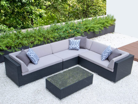 Giant L with glass table and light grey cushions