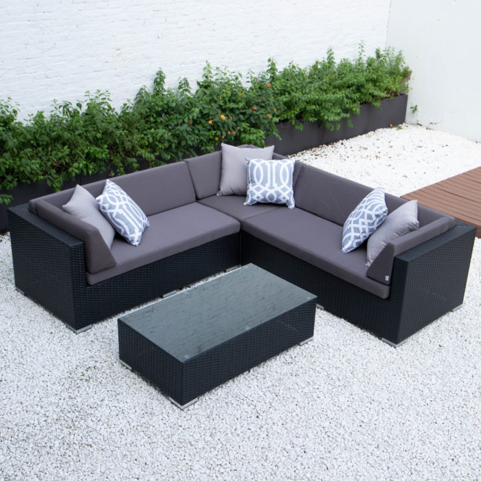 Symmetrical L with glass table in dark grey cushions