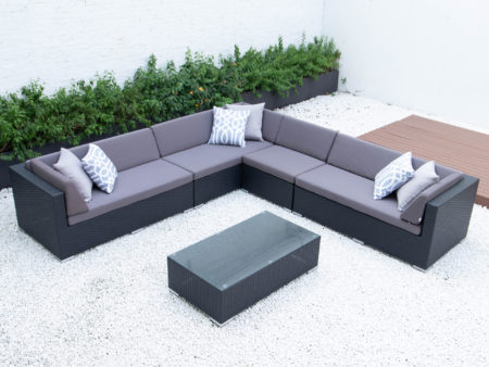 Giant symmetrical L with glass table in dark grey cushions